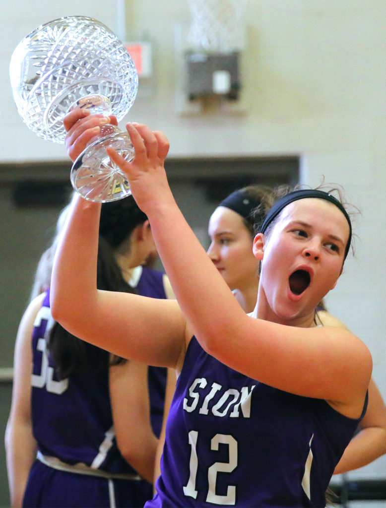 After beating beating St. Teresa’s Academy 50-42, senior and co-captain Mariah Lynn holds the Irish Cup up above her head and yells in victory Saturday, Feb. 24. “I don’t believe the Irish Cup will be going anywhere for a long time,” Lynn said. “I believe the team will hold their own next year, and for right now its all ours.”