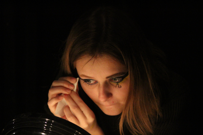 Junior Allison Huff, make-up artist for Joseph and the Amazing Technicolor Dreamcoat, tests prince make-up design on herself. 