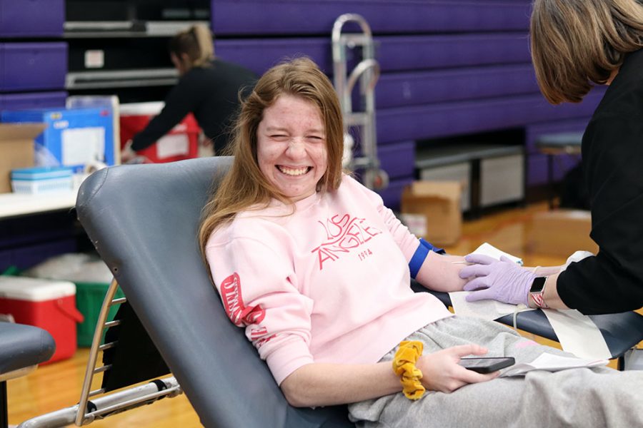 During the annual blood drive Feb. 14, junior Maggie McKinney flinches as the nurse begins to draw blood. McKinney passed out several times after her donation. “I chose to give blood because I felt like I should give back to those in need, especially since millions of people in the country rely on blood transfusions to save their lives,” McKinney said.