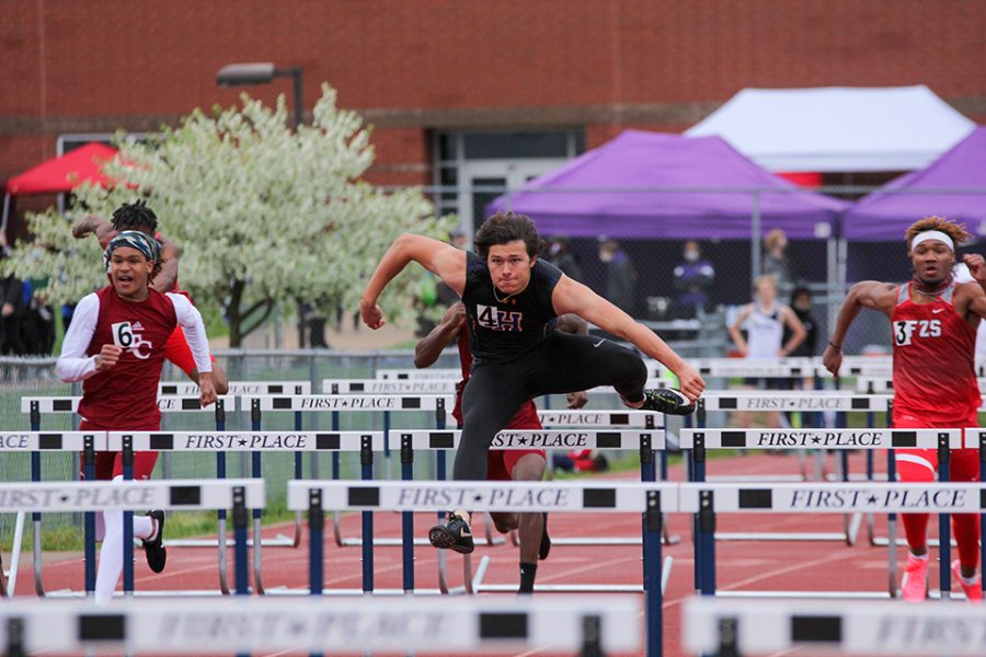 Jumping over the hurdle, senior Bryce Kazmaier races during the 110 meter hurdles at the Timberland Wolf Pack Invite, April 10. Kazmaier won with a time of 14.69 and set a new personal record.