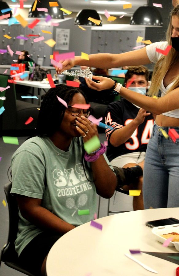 After being announced a top five queen candidate, senior Christiany Miller laughs in disbelief Sept. 17 as she is crowned by senior Hailey Gifford while senior Drew Mangold claps. Miller said she never thought she would have been nominated to be in the top 11, let alone top five. It makes me feel good as a person to know that I have such a positive impact on my classmates, Miller said. Definitely will tell my kids about this. 