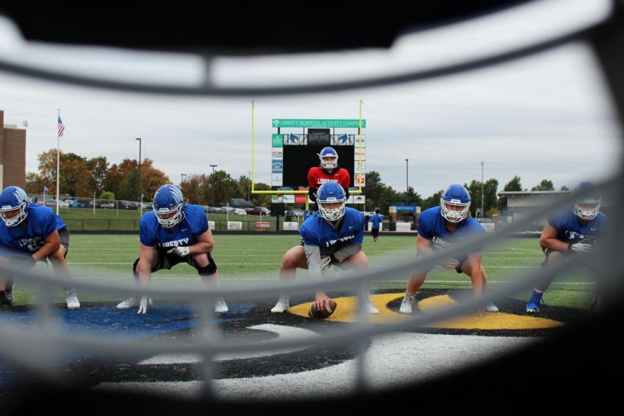 Liberty High School varsity football players, senior Caden Krutsinger, senior Mike Capria, senior Charlie Dipoto, senior Tyler Liniger, junior Corbin Martin, and senior Cam Lawson practice on October 26 at the Liberty High School football field. The team has put forth an immense amount of effort towards making the best of this season. The key factor towards our dedication to the team has mainly been the environment weve made for ourselves. Having each others support encourages us to work our hardest, junior varsity player Sam Pisciotta said. (caption by Kalea Faubion)