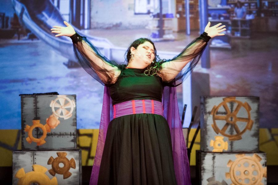 Junior Moria Simanowitz, playing the Wicked Witch of the West, raises her hands at the peak of her song 