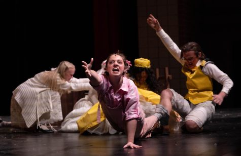 Wilbur the pig, played by senior Anna Wright, grasps for freedom from the Zimmerman's oven during her performance in "Charlotte's Web." This was Wright's favorite moment in the play. "I'm picturing running from an intruder or just like a monster," Wright says about what goes through her head during the scene. "Theater is important to me because it is a way to get a bunch of people with nothing to do in common in the same room to laugh together, to cry together, and teach moral lessons right in front of their eyes. And it's really fun."