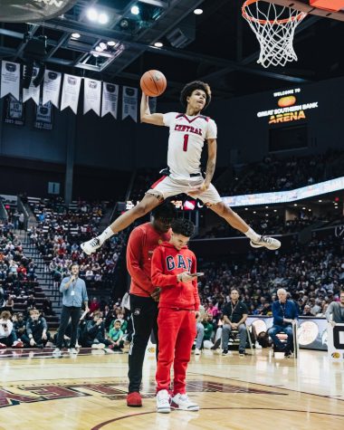 During the Bass Pro Tournament of Champions Dunk Contest Jan. 14, Central High School junior Antonio Starks-Fewell leaps over two people for the slam dunk. Starks-Fewell was one of the local players in the contest, where he finished third.