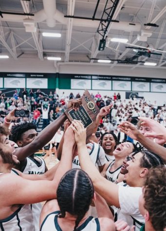 After Beating Oak Park High School 56-49 in the Class 6 District 8 Championship March 6, the boys basketball team celebrates their fourth straight district championship. The team previously beat Oak Park 64-36 on Dec. 15, but the team knew Oak Park would be a harder matchup now. “We knew that was probably the toughest team we were going to play all year,” senior guard Jared Lee said. “When we won, it was just a crazy feeling that we got that done because a lot of people didn’t think we could.”