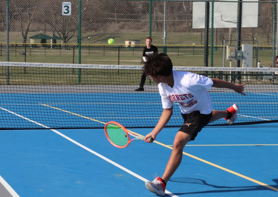 SMOOTH MOVES: Junior Nick Nguyen moves quickly to return the ball over the net during the first home tennis match of the season on March 27. Nguyen says that his consistency while playing has improved this season. “I feel like I do need to improve on my doubles work though,” Nguyen said.
