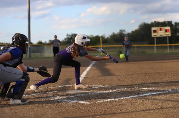 Tap It In Play. Natilie Biere (7) squares up for a bunt against the Brookfield Bulldogs in the home game on October 4th. Biere made contact with the ball, placing it down the first base line. While Biere was thrown out at first, she advanced base runner, Anastyn Carter (8), to second base. 