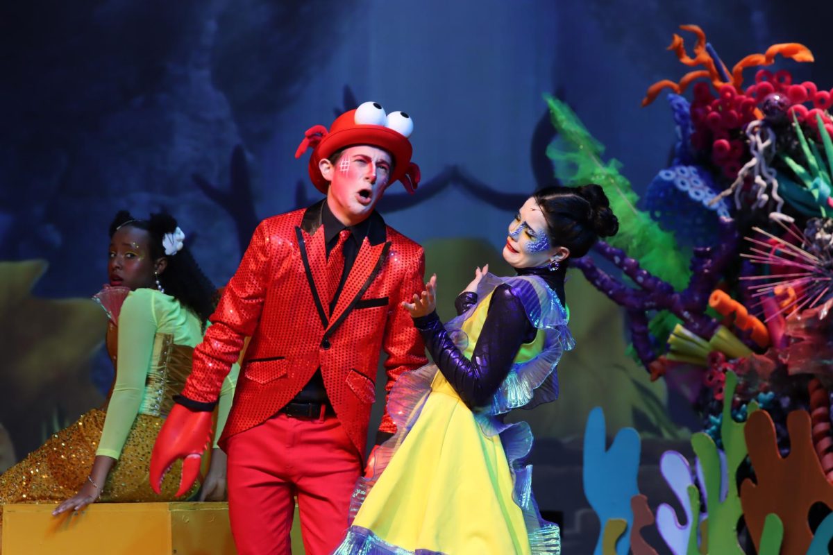 Singing to Flounder, senior Sam Ragone performs as Sebastian in the theatre departments musical production of The Little Mermaid with senior Kaitlyn Seim. A lot of character work went into studying Sebastians crab walk, burning his legs after every show. Im pretty grateful that I got Sebastian, because not only did I get to sing some of the pretty iconic songs, but it was really fun to see how I could fit into the character as my own self, Ragone said. 