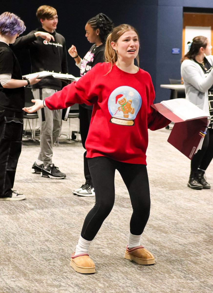 "ESCAPING REALITY.
Sophomore Olivia Dolton works with her teammates for their upcoming Readers Theatre performance Superheroes on February eighth. Students at LHS could join the Readers Theatre club to create a performance and compete at competitions with elaborate scripts to practice their acting skills. Dolton and her classmates' performance was based on superheroes such as Batman, Wonder Woman and even sidekicks like Robin. Dolton was acting in scene four, playing the role of a southern lady in distress screaming for Aquaman to save her. “I like Readers Theatre because you are given nothing but a binder and a script so you have to build your story from scratch and show the judges the importance of our story,” Dolton said. Photo by Brooke Roseberry."