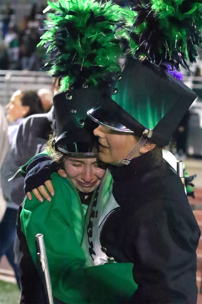 "In a tearful embrace during the Falcon Brigade’s Senior Night Oct. 25, senior Leah Folkman hugs junior Salma Castillo. At halftime, seniors were recognized and stepped out of their shoes to make way for underclassmen. “It was definitely an emotional feeling,” Castillo said. “I have a lot of friends that are seniors this year, since I’m a junior this year, and watching them have them their last marching season and knowing mine was coming up, too, was a sad feeling, but also a joyous feeling because I’m glad I got to be there in that moment with them.”