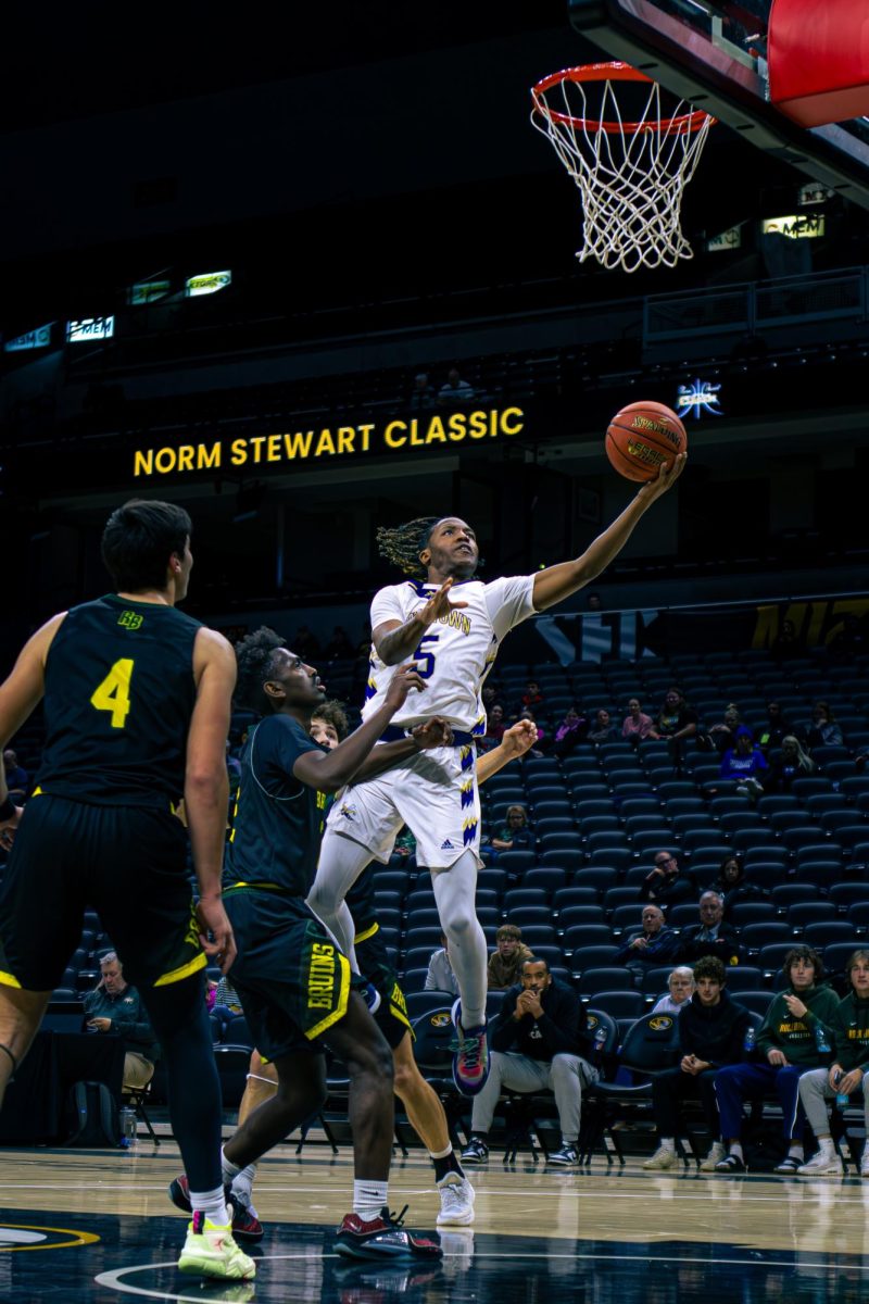 AND ONE: Flying in for a layup, senior guard Kam Tate is fouled on his shot while still getting it to go down. Tate went on to hit the free throw to cut the Rock Bridge lead down to three, and set up a game tying three-point shot to send the game into overtime. "We just gotta out hustle everyone else and get to bucket," Tate said.