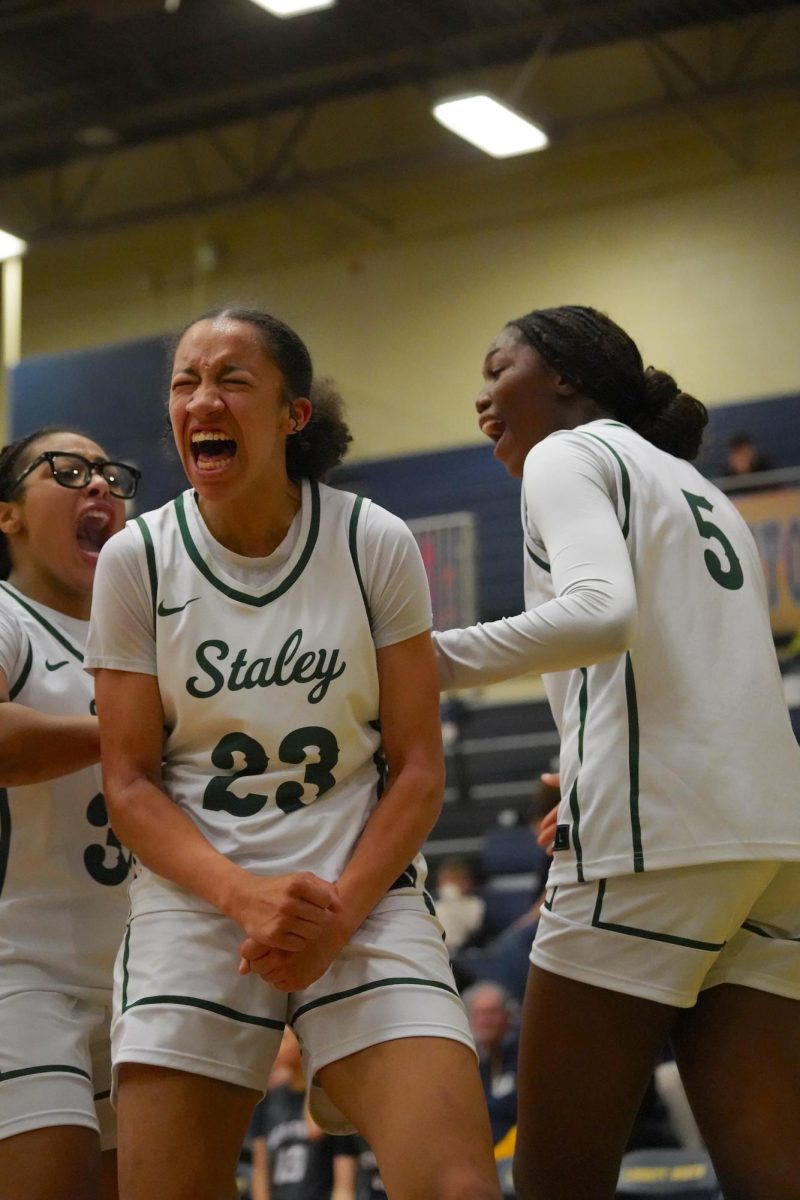 During a varsity basketball game against St. Joseph Benton High School at the Liberty North Invitational Tournament, junior Ava Miles celebrates after she made a shot. Lasting all tournament, Miles had the flu but still continued to play, and the team won the tournament championship. “I was sick during this game, so it took everything out of me to play,” Miles said, “but I am a very passionate person, so a little sickness can’t stop me from being passionate and playing.”  