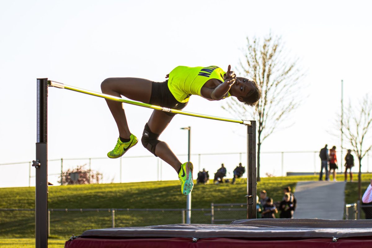 REACHING NEW HEIGHTS: Sophomore D'Mya Newton glides over the high jump bar, setting a new personal record of 5 feet, 3.75 inches. Nine area track and field teams competed at the 21st Annual Jerry Crews Track and Field Invitational on April 11 at the NKCSD District Activities Complex. D'Mya Newton placed second overall in the high jump event, only behind her older sister, Dede Newton, who jumped 5 feet, 9.25 inches for the top finish.