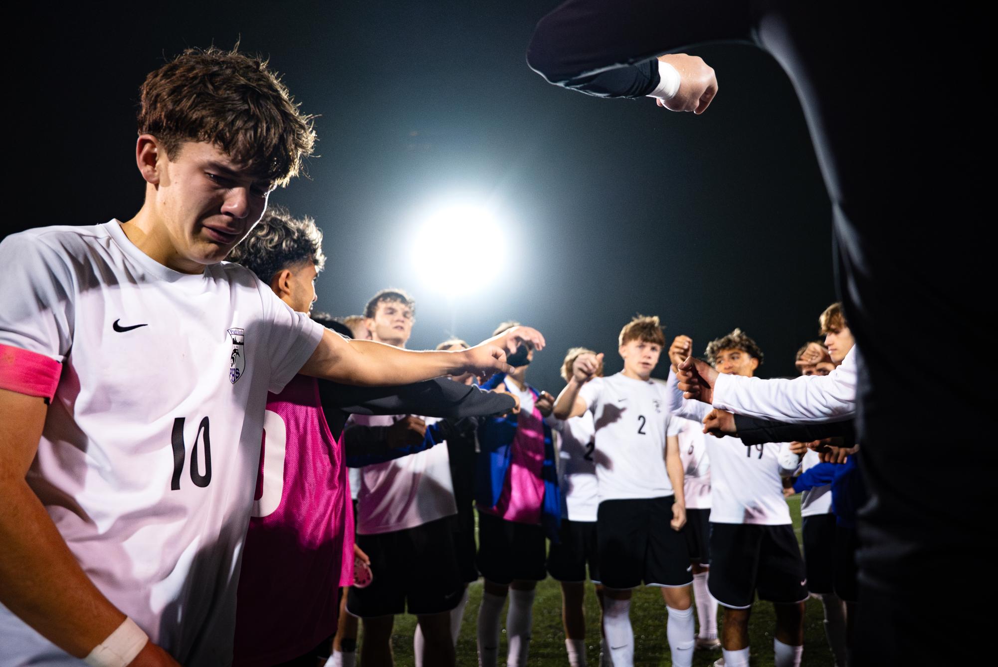Soccer captain Will Bowne gets emotional after a heartbreaking loss to Rockhurst in the Missouri state semifinals. Bowne gathered with his teammates after the for what would be one of the final huddles of his high school career.